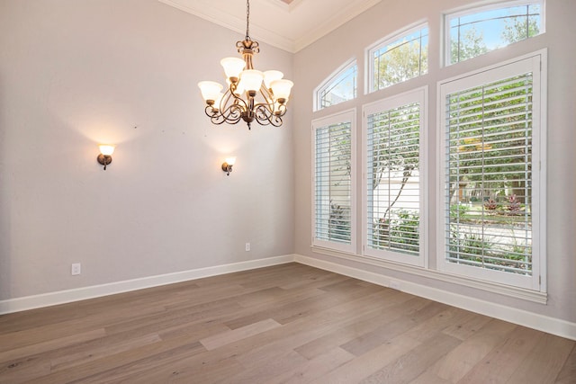 spare room with ornamental molding, a healthy amount of sunlight, and hardwood / wood-style floors