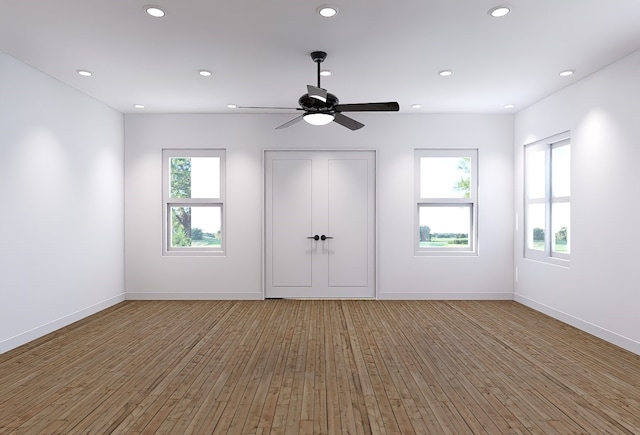 interior space featuring a wealth of natural light, hardwood / wood-style floors, and ceiling fan