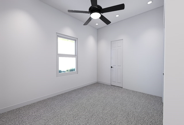 carpeted spare room featuring ceiling fan