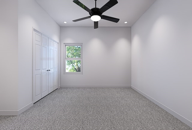 unfurnished room featuring ceiling fan and carpet floors