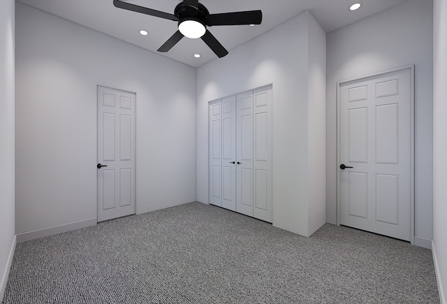 unfurnished bedroom featuring carpet floors and ceiling fan