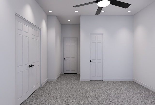 interior space with carpet and ceiling fan