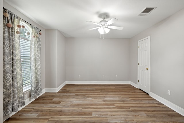 empty room with ceiling fan and hardwood / wood-style flooring