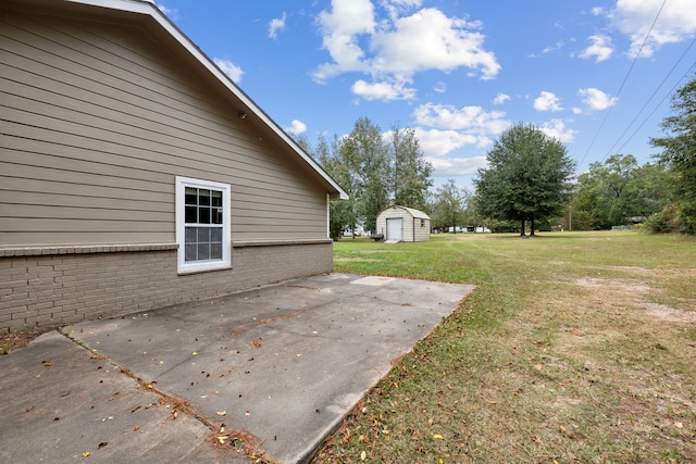 view of yard featuring a patio and a storage unit