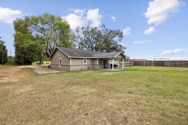 rear view of property featuring a patio area and a lawn