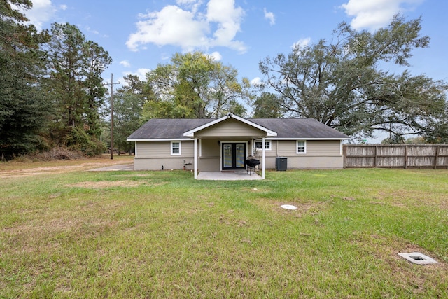 rear view of property featuring a lawn and a patio area