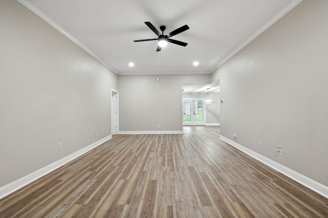 unfurnished living room with ceiling fan, light wood-type flooring, and crown molding