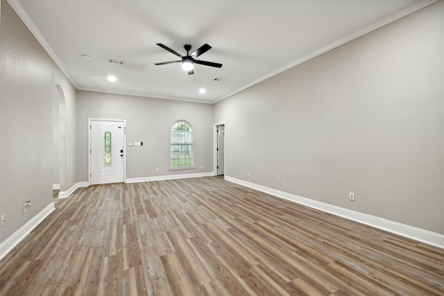 empty room with light hardwood / wood-style floors, ceiling fan, and ornamental molding