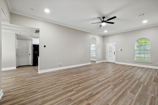 unfurnished living room with ceiling fan, crown molding, and light hardwood / wood-style flooring