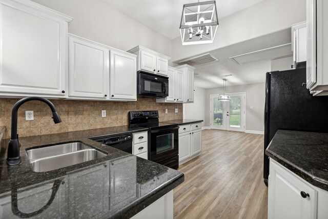 kitchen featuring sink, decorative light fixtures, white cabinetry, and black appliances