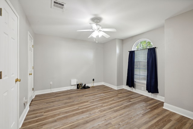 empty room with ceiling fan and hardwood / wood-style floors