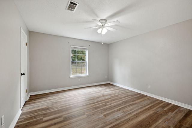 empty room featuring hardwood / wood-style flooring and ceiling fan