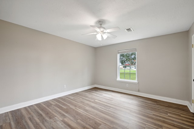 spare room featuring hardwood / wood-style floors, a textured ceiling, and ceiling fan