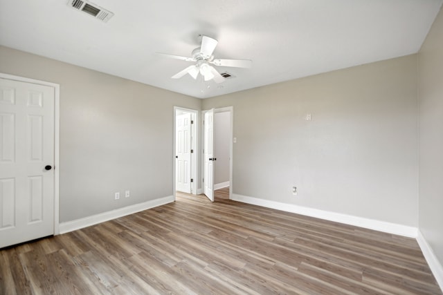 unfurnished bedroom featuring hardwood / wood-style flooring and ceiling fan