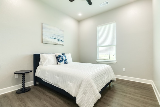 bedroom with dark wood-type flooring and ceiling fan