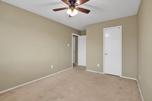 unfurnished bedroom with ceiling fan and light colored carpet