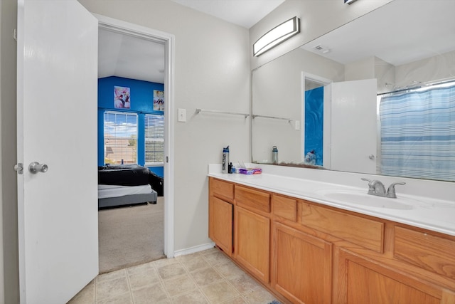 bathroom with vanity and lofted ceiling