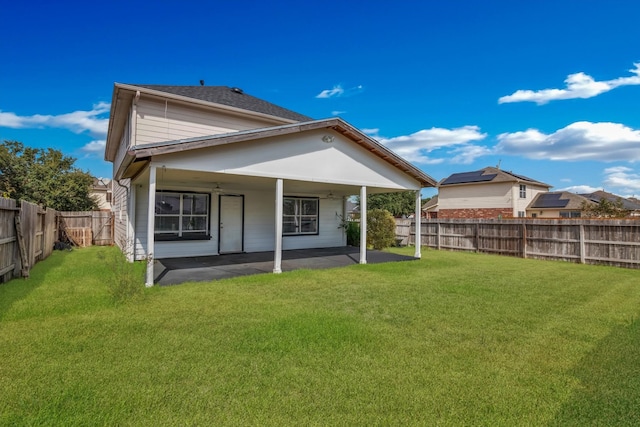 rear view of property featuring a patio area and a yard