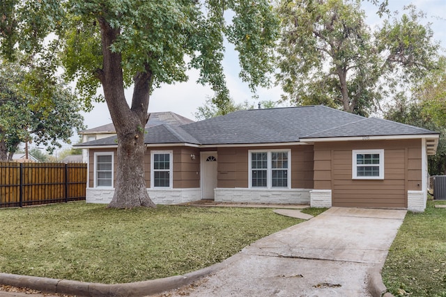 ranch-style home with cooling unit and a front lawn