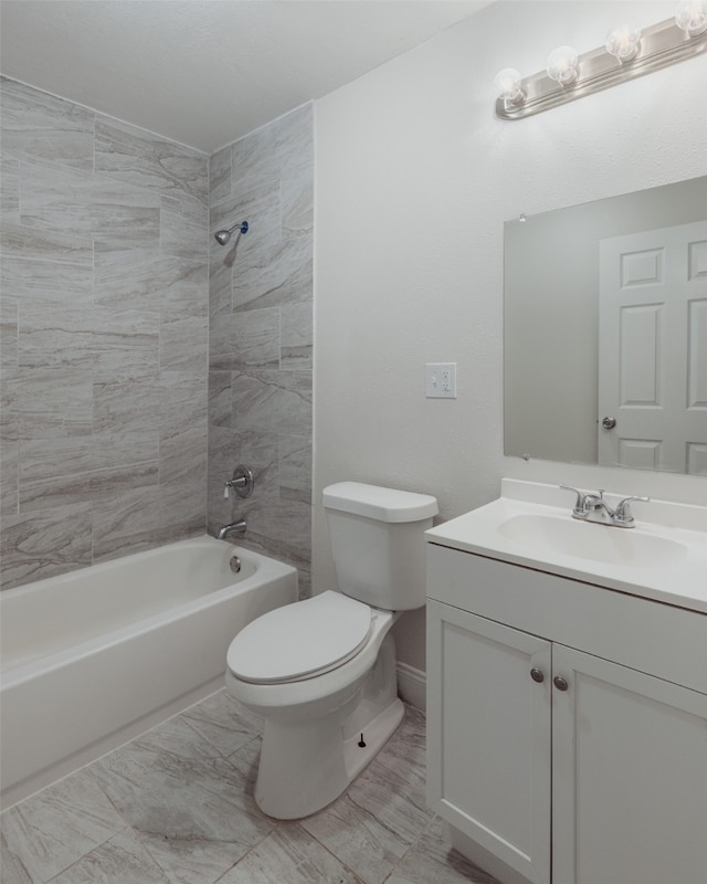 full bathroom featuring vanity, tiled shower / bath combo, and toilet