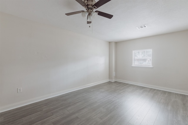 unfurnished room with ceiling fan and dark hardwood / wood-style floors