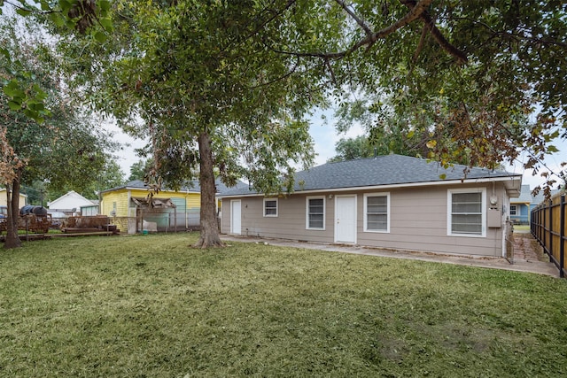 rear view of house with a yard