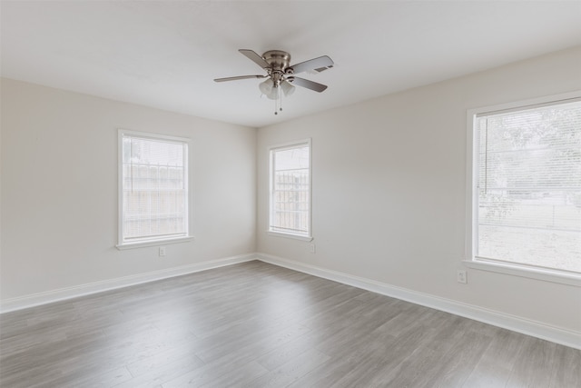 unfurnished room featuring light wood-type flooring, plenty of natural light, and ceiling fan