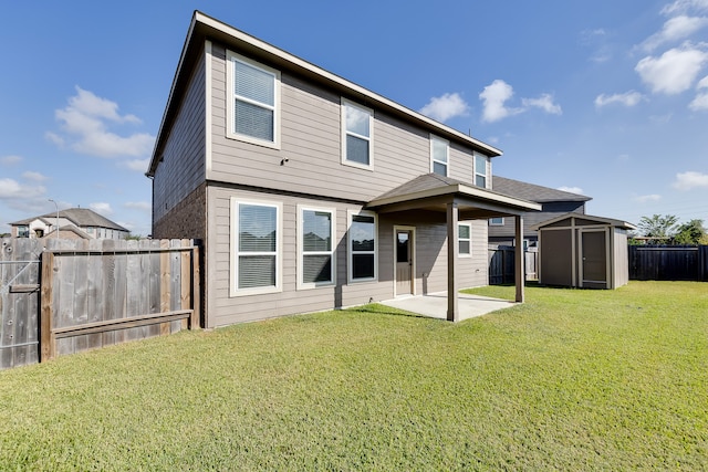 back of property featuring a storage unit, a yard, and a patio area