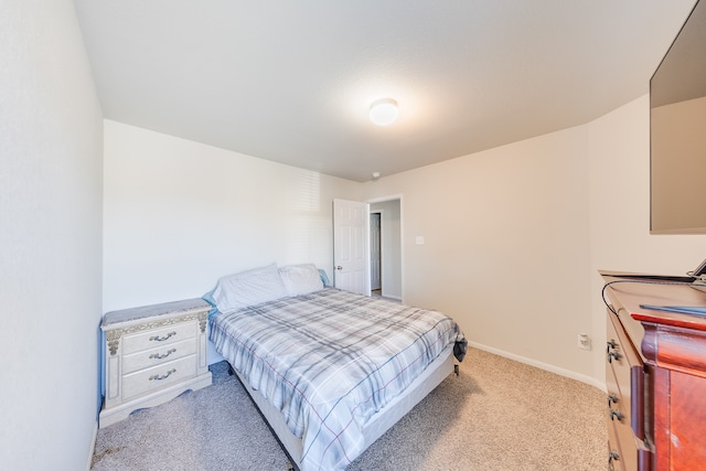 bedroom featuring light carpet