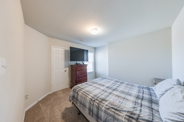 carpeted bedroom with a textured ceiling