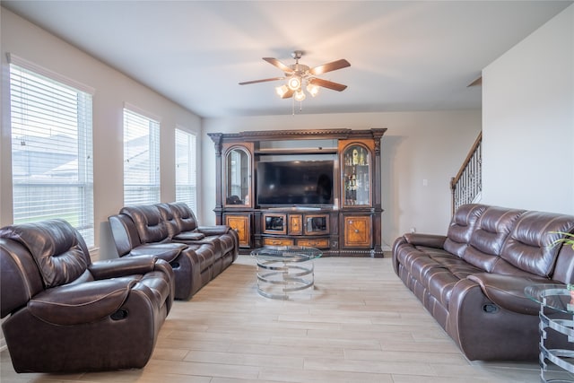 living room with light wood-type flooring and ceiling fan