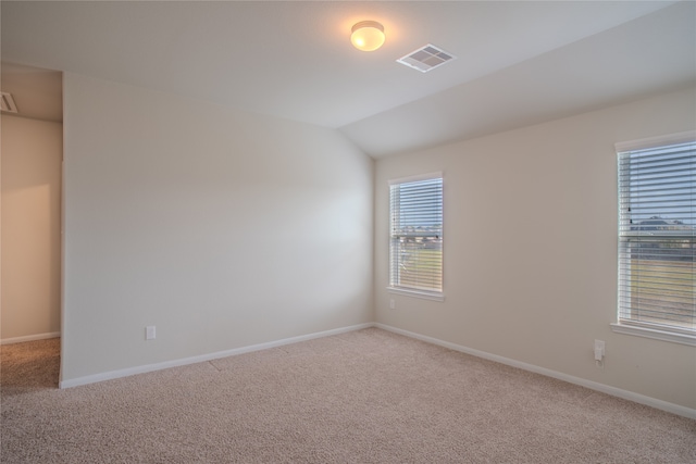 spare room with lofted ceiling and carpet floors