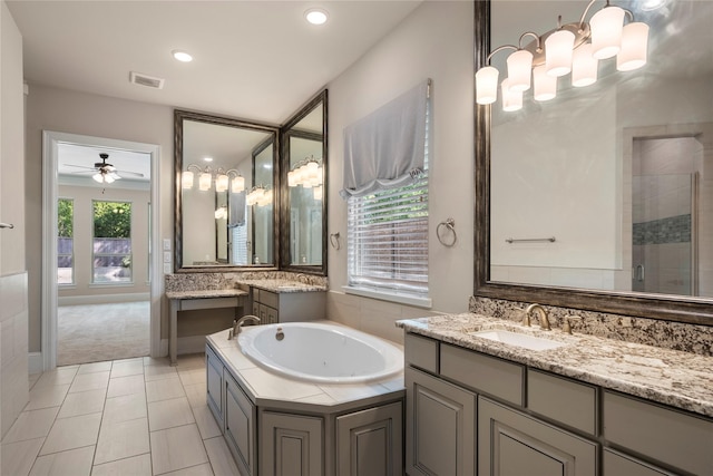 full bath with a bath, ceiling fan, two vanities, a tile shower, and tile patterned flooring