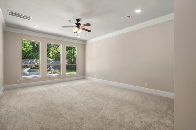 unfurnished room featuring ceiling fan, ornamental molding, and light carpet