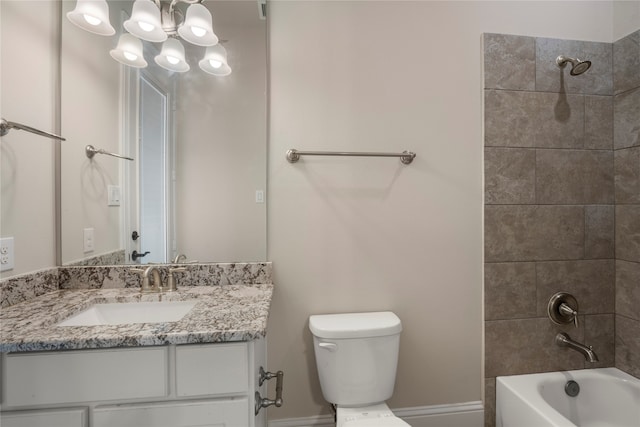 full bathroom featuring tiled shower / bath combo, toilet, and vanity