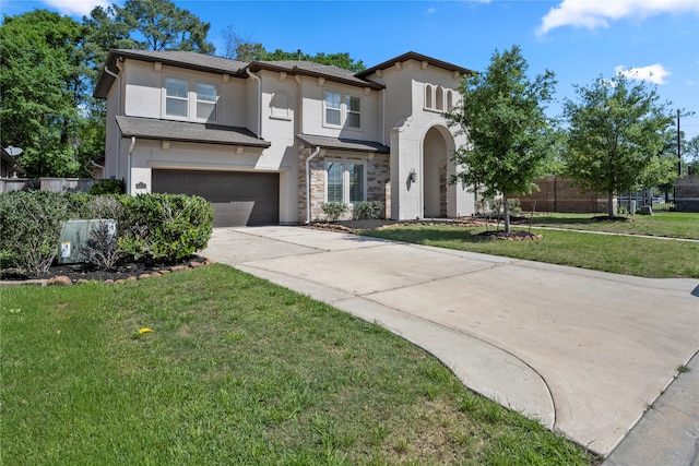 view of front of home with a garage and a front lawn