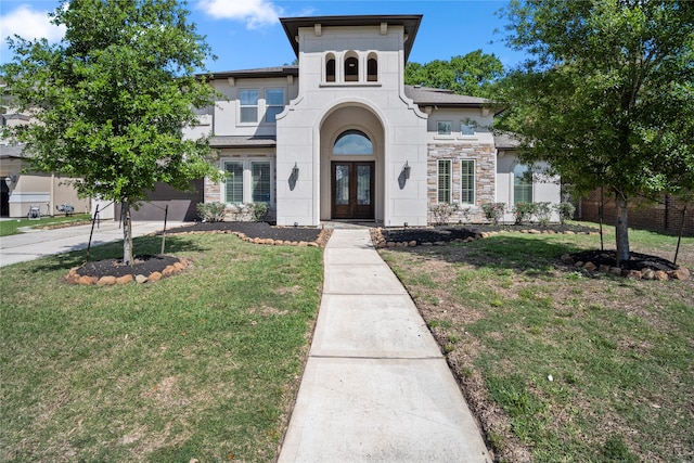 view of front facade with french doors and a front lawn