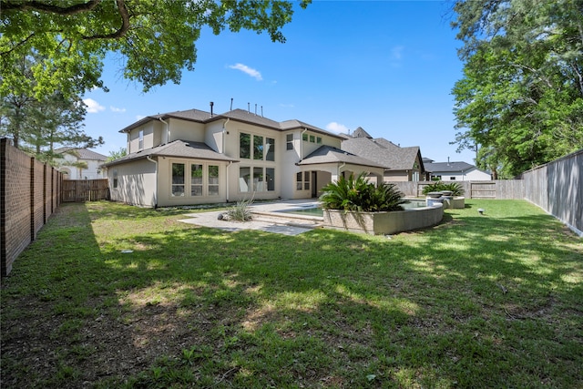 rear view of property with a fenced in pool and a lawn