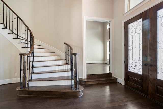 foyer with dark hardwood / wood-style flooring, french doors, and a high ceiling