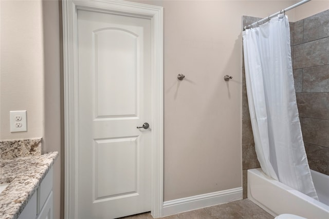 bathroom with shower / tub combo with curtain, vanity, and tile patterned flooring