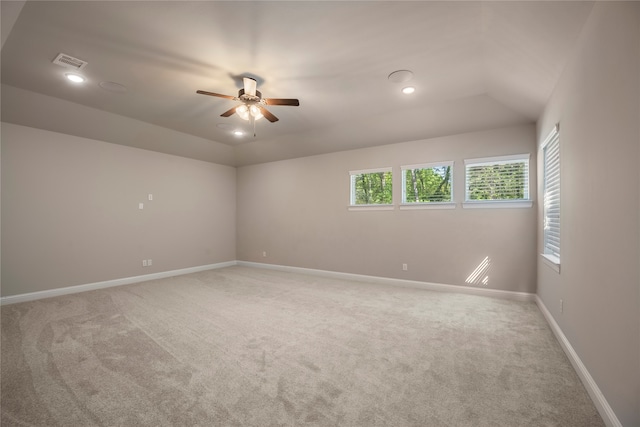 carpeted spare room featuring ceiling fan and lofted ceiling