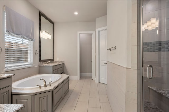 bathroom featuring tile patterned flooring, vanity, and independent shower and bath