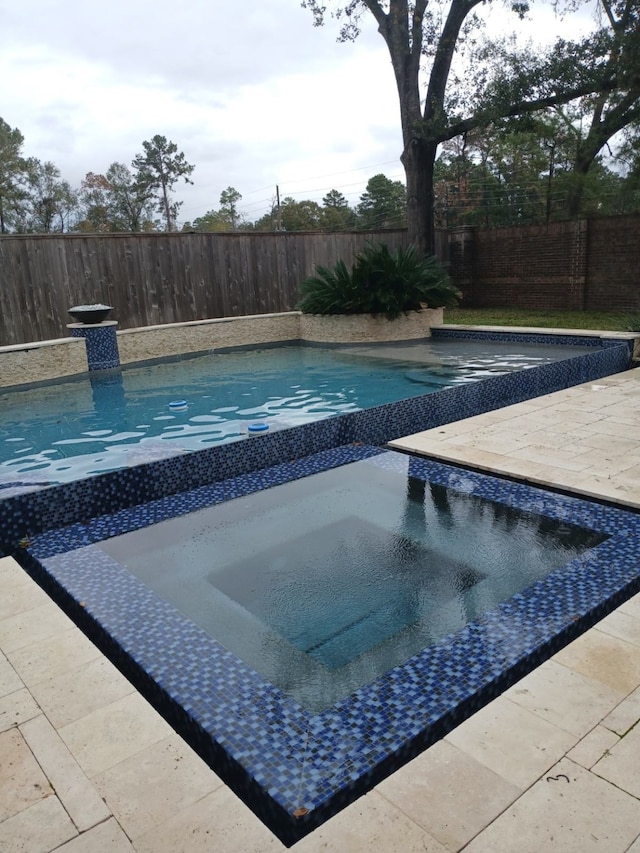 view of pool with an in ground hot tub