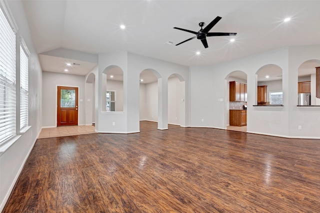 unfurnished living room featuring ceiling fan and light hardwood / wood-style flooring