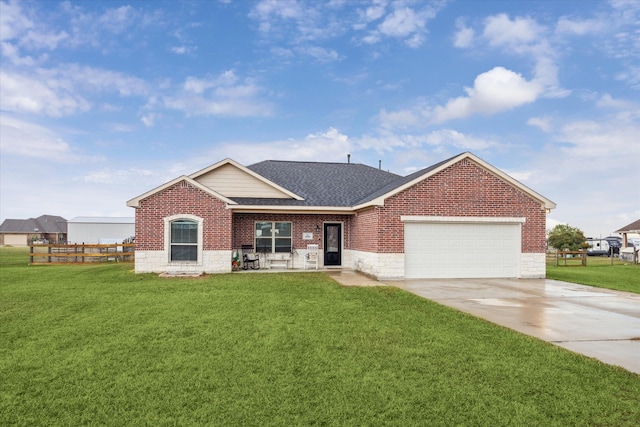 view of front of home with a front yard and a garage