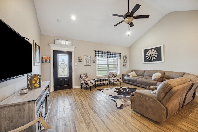 living room featuring light hardwood / wood-style flooring, high vaulted ceiling, and ceiling fan