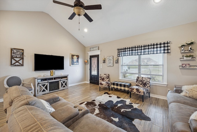 living room with ceiling fan, high vaulted ceiling, and light wood-type flooring