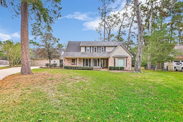 view of front facade with a garage, a front lawn, and a porch