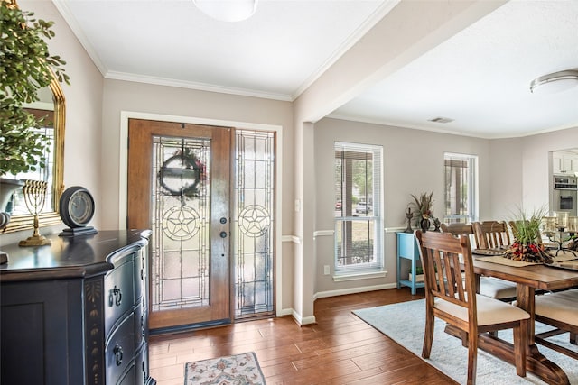 foyer featuring ornamental molding and dark hardwood / wood-style floors