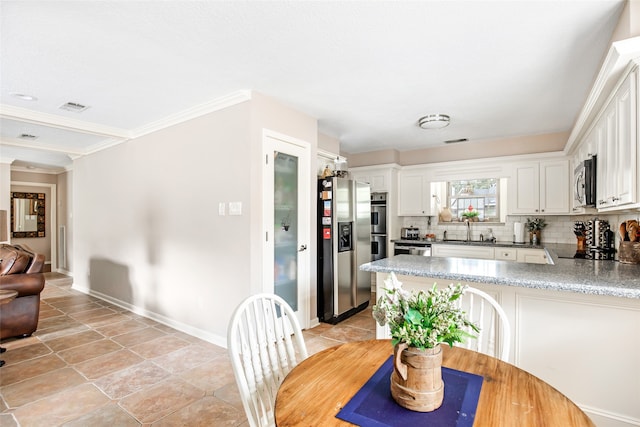 dining room with ornamental molding and sink